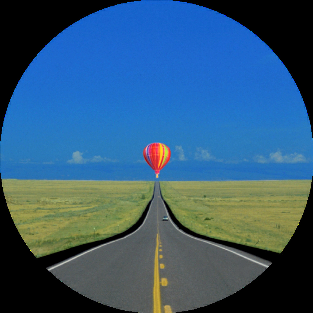 A balloon floating at the end of a road